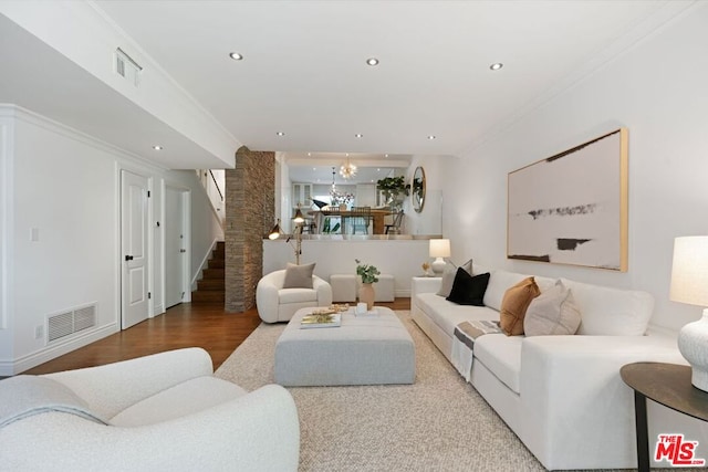 living room with ornamental molding and hardwood / wood-style flooring