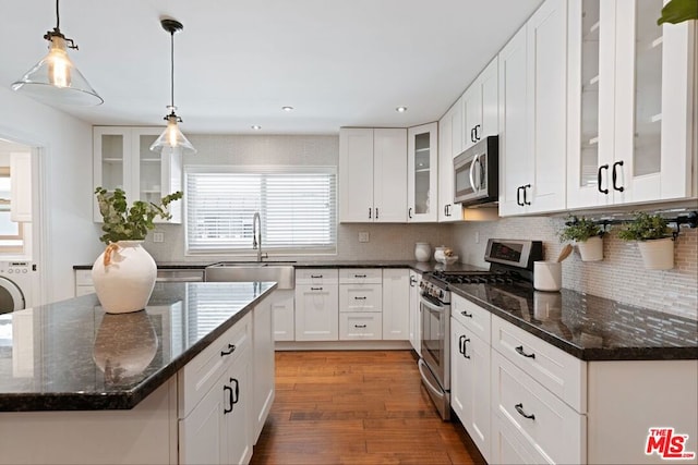 kitchen featuring sink, decorative light fixtures, white cabinetry, and appliances with stainless steel finishes