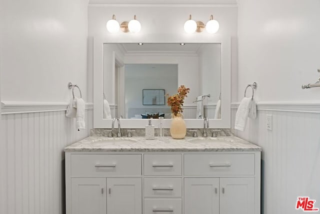 bathroom with crown molding and vanity