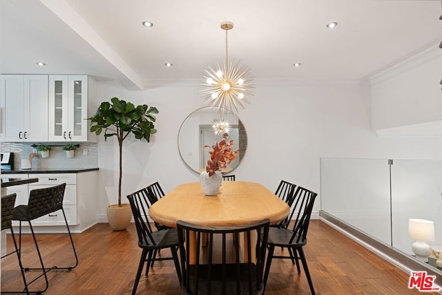 dining space featuring a notable chandelier, dark wood-type flooring, and crown molding