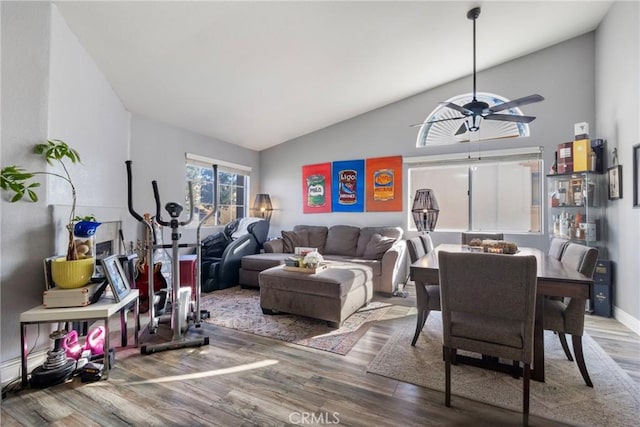 living room featuring ceiling fan, wood-type flooring, and lofted ceiling