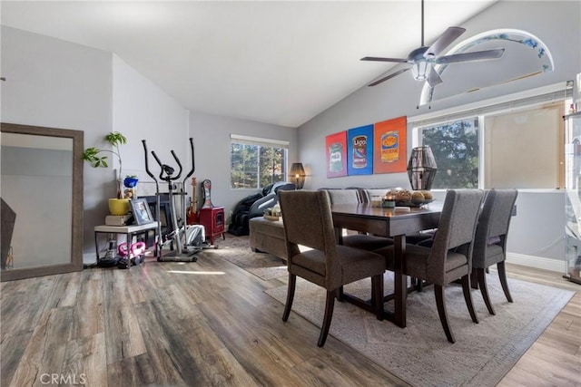 dining area featuring vaulted ceiling, ceiling fan, and wood-type flooring