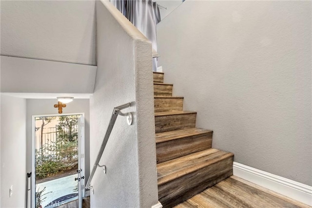 stairs with hardwood / wood-style floors