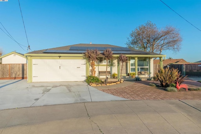 view of front of property with solar panels and a garage