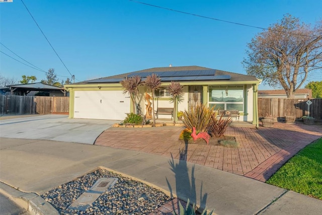 view of front of home with a garage and solar panels