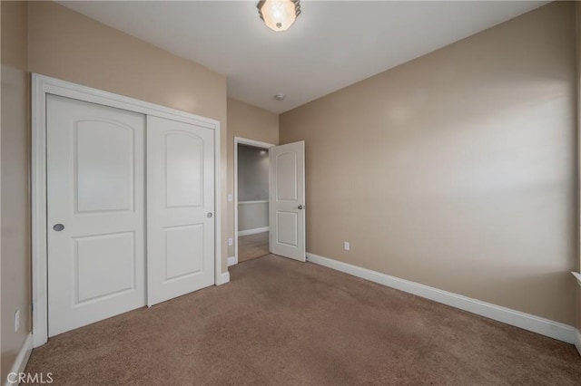 unfurnished bedroom with a closet and carpet floors