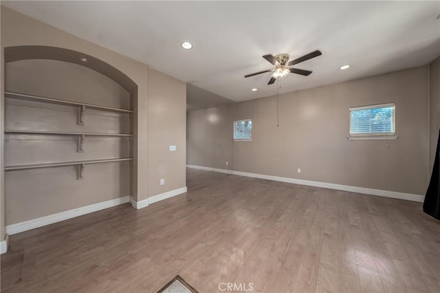 empty room with ceiling fan and hardwood / wood-style flooring