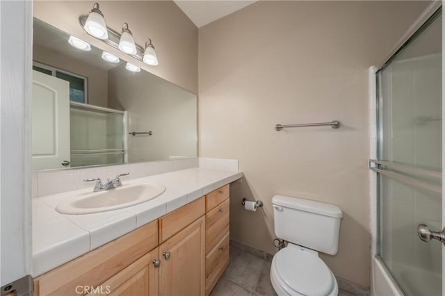 full bathroom featuring vanity, toilet, enclosed tub / shower combo, and tile patterned flooring