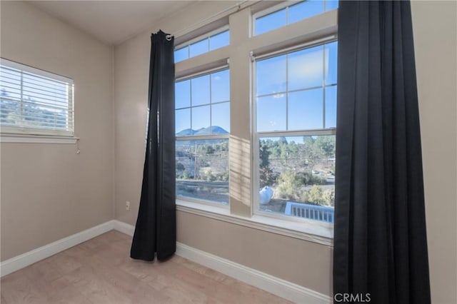 empty room with light hardwood / wood-style flooring