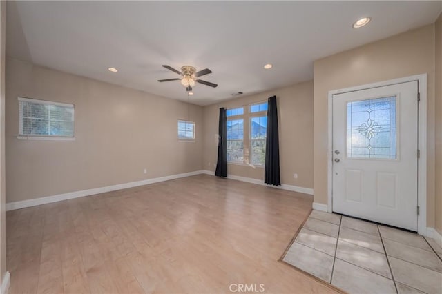 entryway with ceiling fan and light hardwood / wood-style flooring