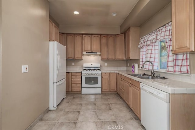 kitchen with sink, white appliances, and light brown cabinets