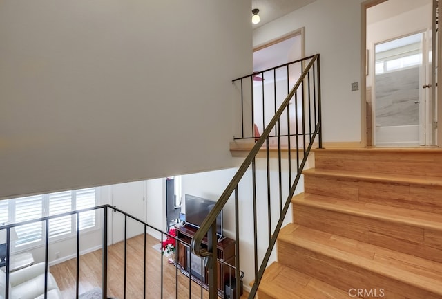 stairs featuring hardwood / wood-style floors