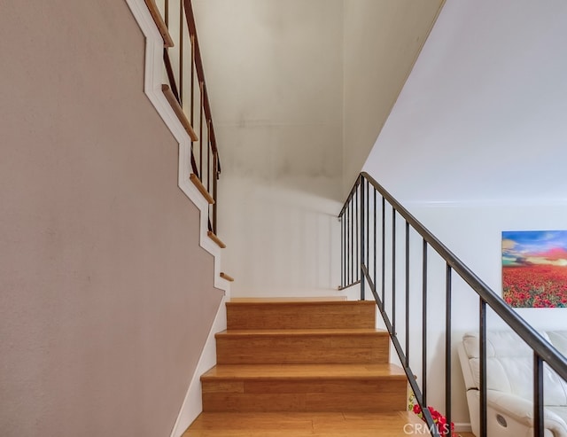 stairs with hardwood / wood-style flooring