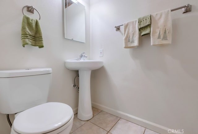 bathroom with toilet and tile patterned flooring