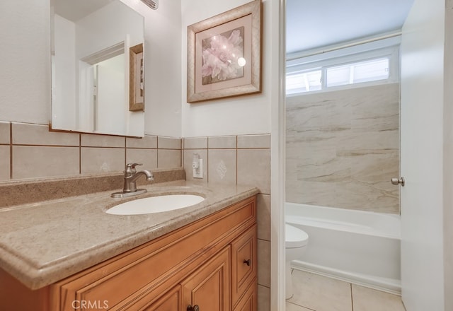 full bathroom featuring toilet, tiled shower / bath combo, and vanity