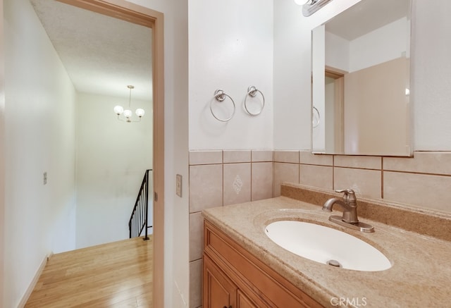 bathroom with vanity and an inviting chandelier