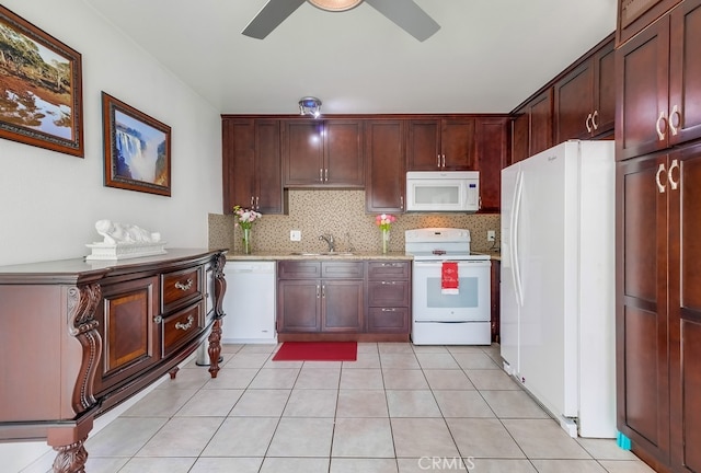 kitchen with white appliances, ceiling fan, light stone counters, sink, and tasteful backsplash