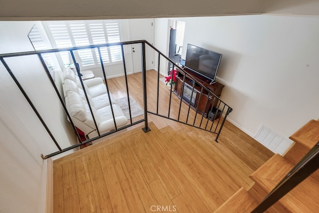 stairway with hardwood / wood-style flooring