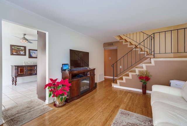 living room featuring ceiling fan and light hardwood / wood-style floors