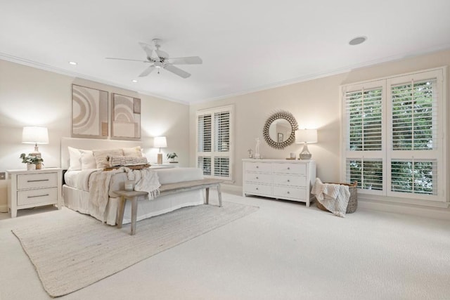 carpeted bedroom with ceiling fan and ornamental molding