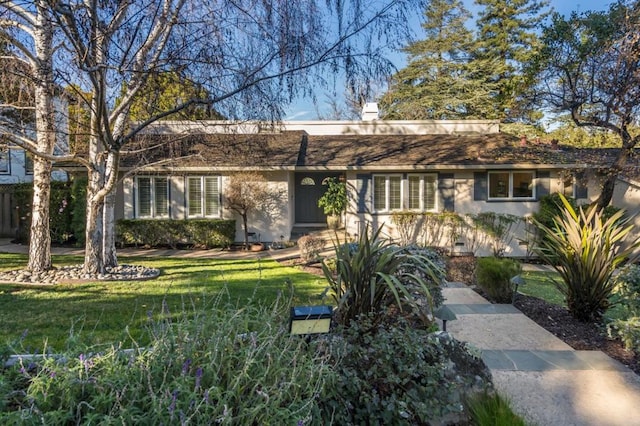 ranch-style home with a front yard