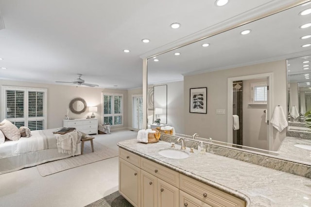 bathroom with ceiling fan, vanity, and ornamental molding