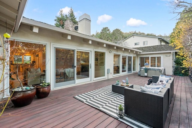 wooden deck with an outdoor hangout area and a hot tub