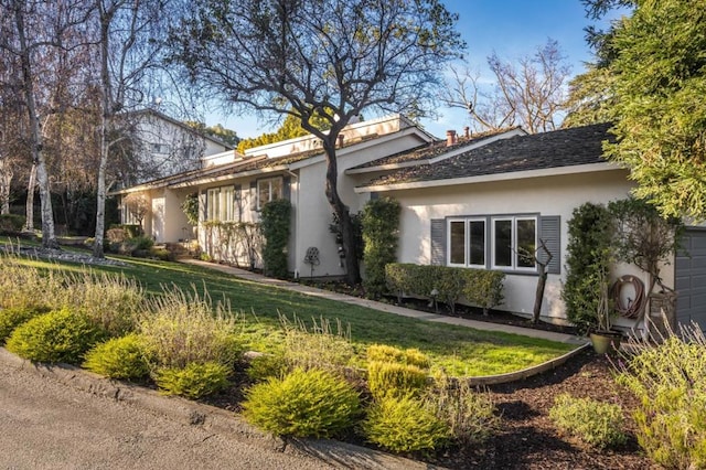 view of side of home featuring a yard