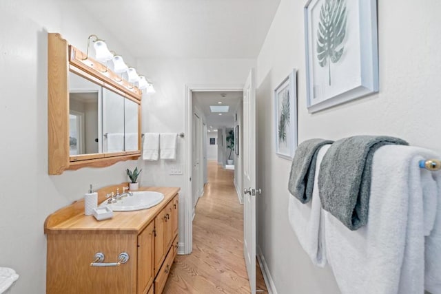 bathroom with hardwood / wood-style floors and vanity