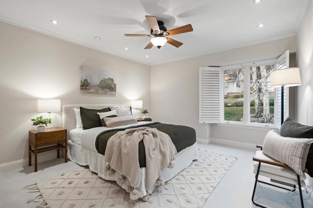 carpeted bedroom with ceiling fan and ornamental molding