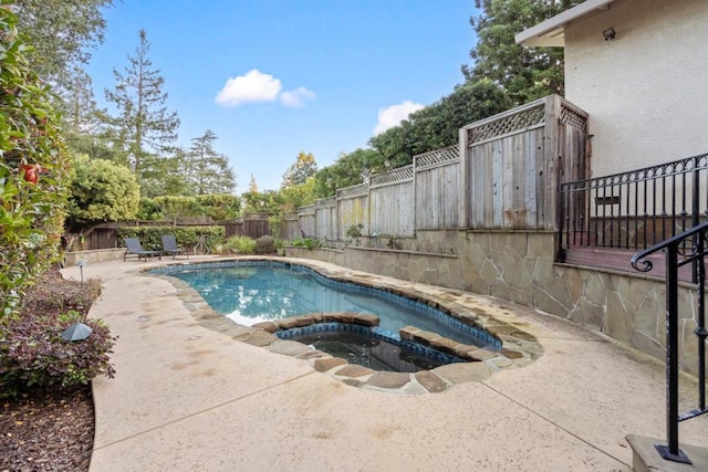 view of swimming pool with a patio area and an in ground hot tub