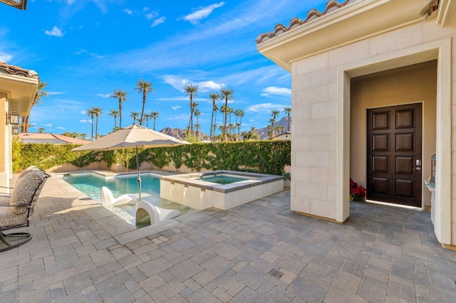 view of swimming pool with an in ground hot tub and a patio