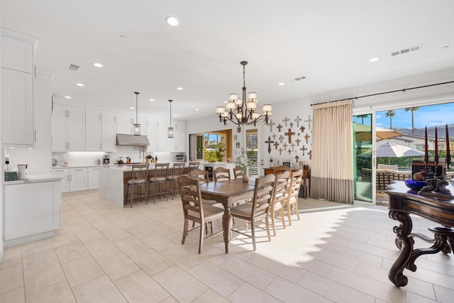 tiled dining space with an inviting chandelier