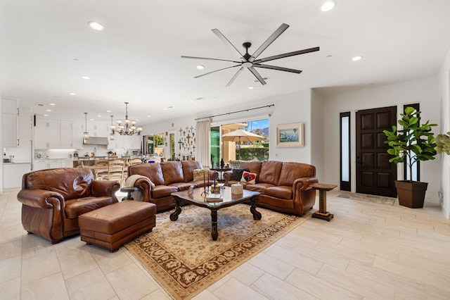 living room featuring ceiling fan with notable chandelier and light tile patterned floors