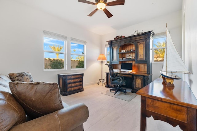 home office featuring ceiling fan and light hardwood / wood-style flooring