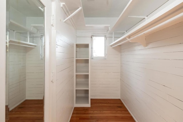 walk in closet with hardwood / wood-style flooring