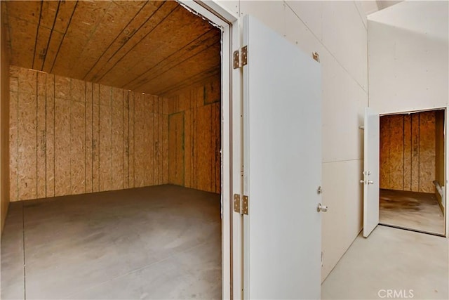 bonus room featuring wood walls and wood ceiling