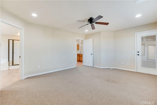 carpeted spare room with ceiling fan