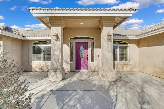 entrance to property featuring a patio area