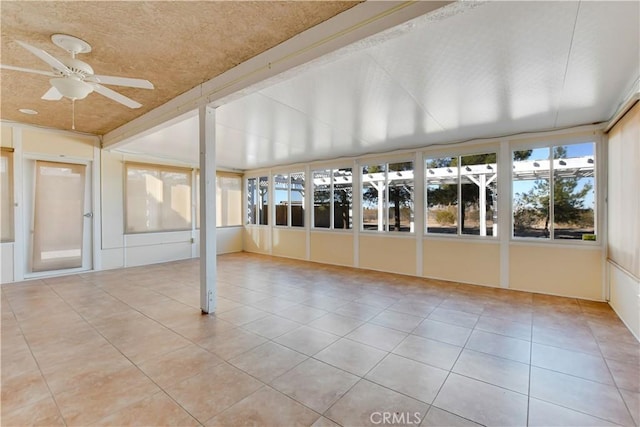 unfurnished sunroom featuring ceiling fan