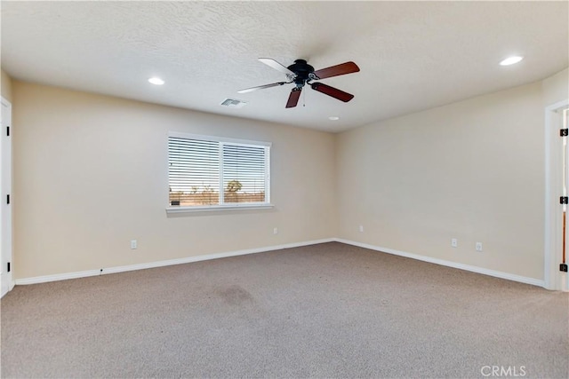 carpeted spare room with ceiling fan