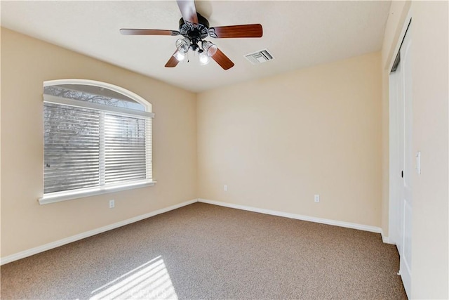 empty room with carpet flooring and ceiling fan