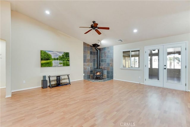 unfurnished living room featuring vaulted ceiling, french doors, ceiling fan, and light hardwood / wood-style floors