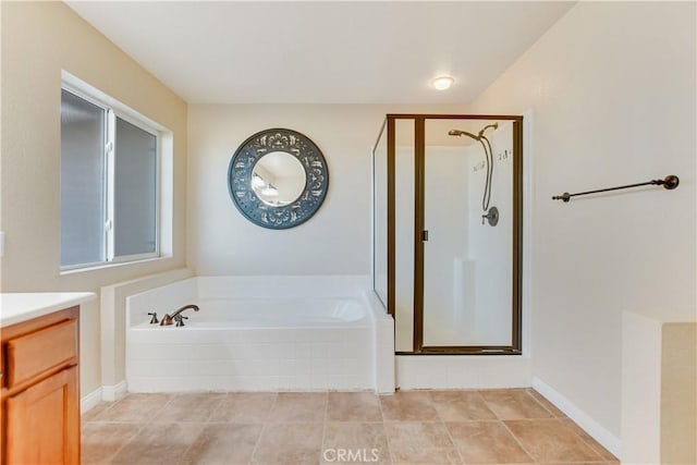 bathroom with tile patterned flooring, independent shower and bath, and vanity