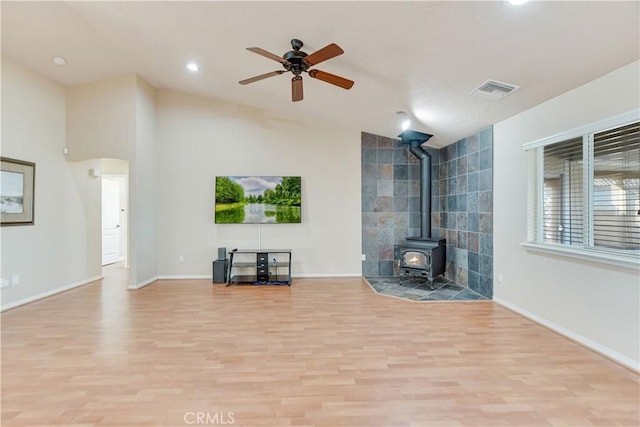 unfurnished living room with ceiling fan, light hardwood / wood-style floors, and vaulted ceiling