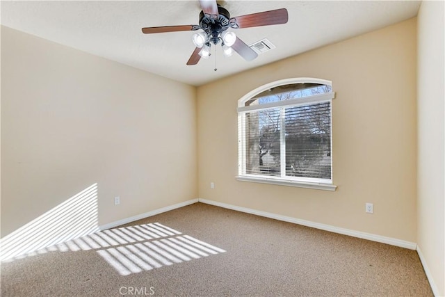 spare room featuring ceiling fan and carpet