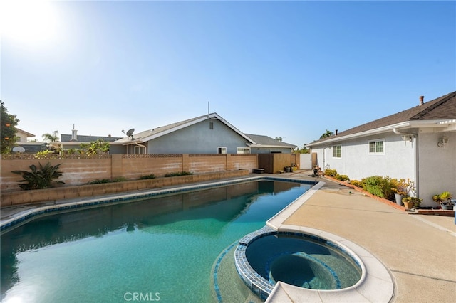 view of pool with an in ground hot tub