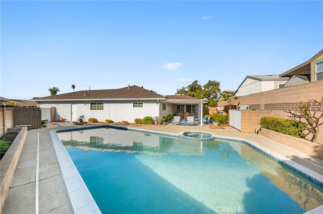 view of swimming pool featuring an in ground hot tub and a patio area