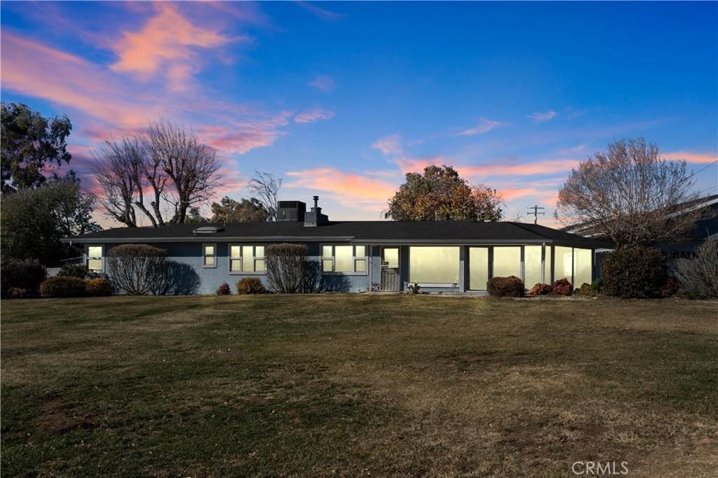 ranch-style house with a yard