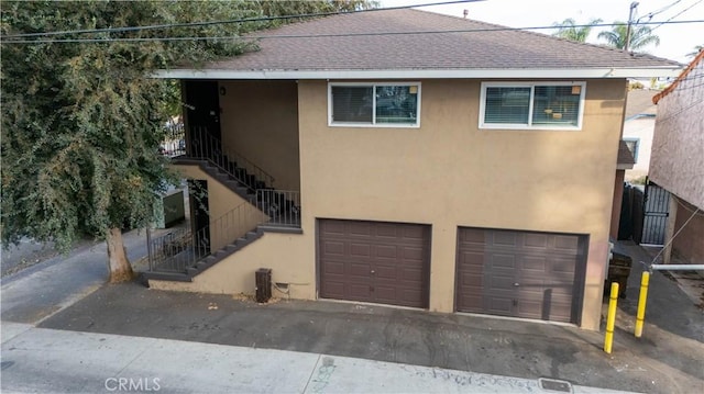 view of front of property with cooling unit and a garage